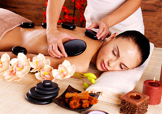 a woman receiving a hot stone massage