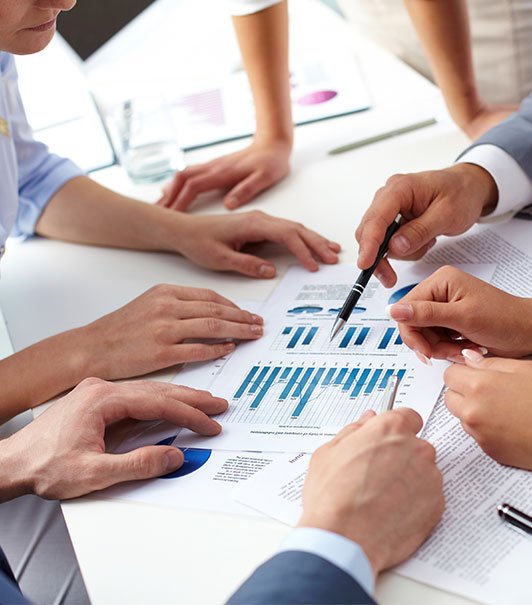 view of a business meeting looking at reports