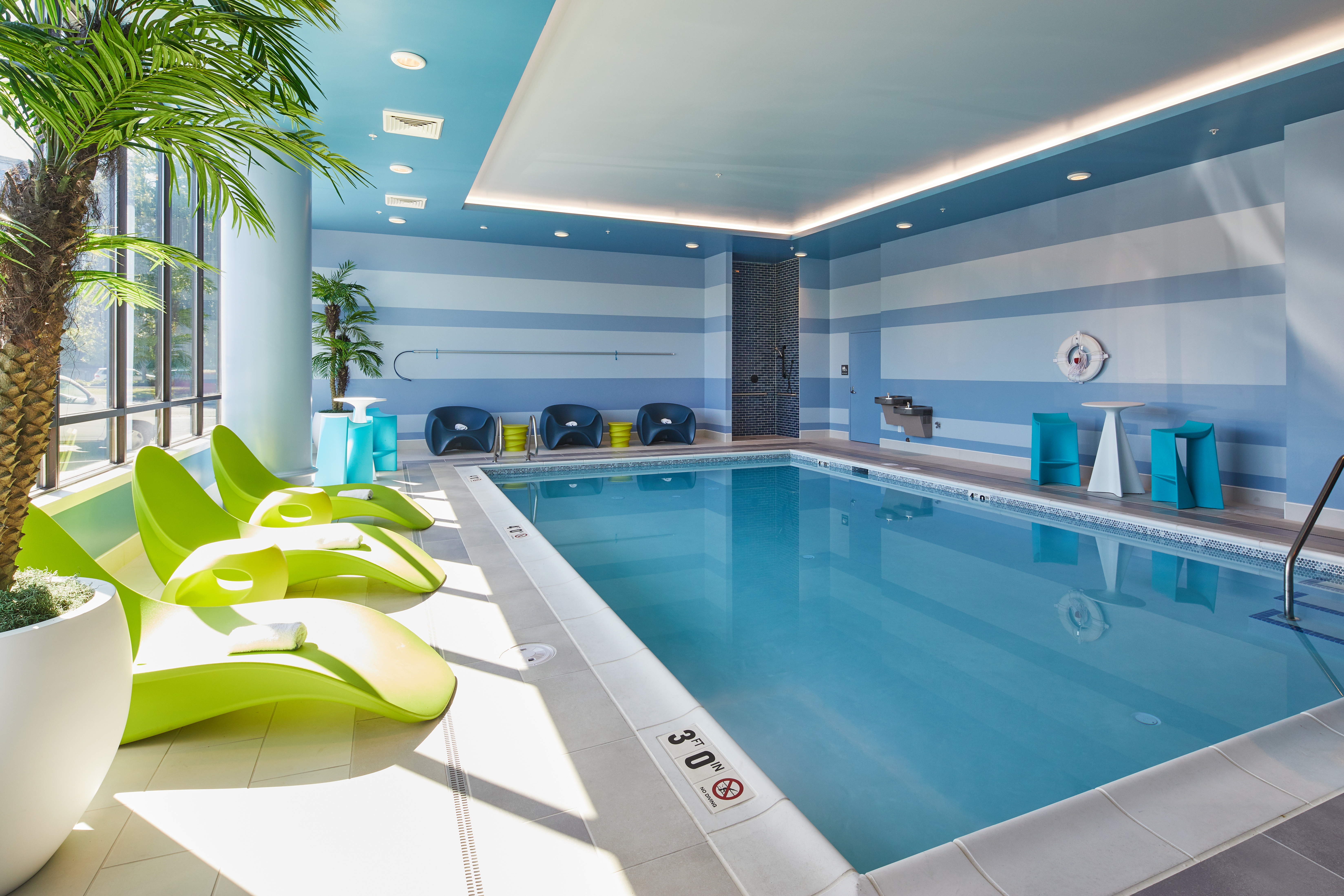 indoor pool with lounge chairs