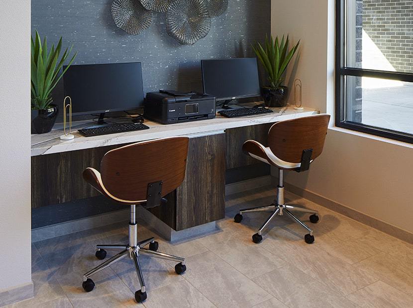 Desk with two chairs and two computers