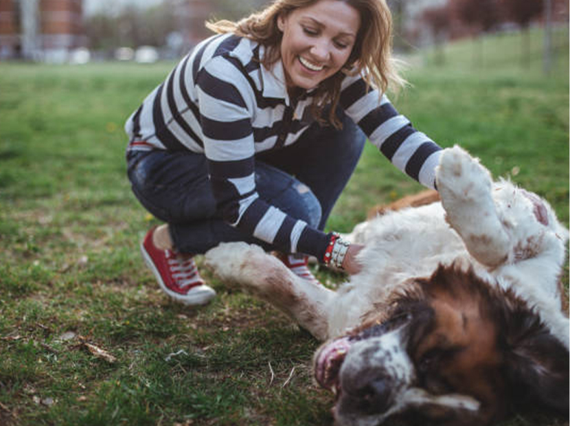 woman playing with her dog outside