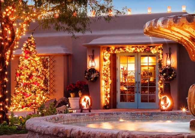 Patio with glass doors to inside and pond, all lit with holiday lights