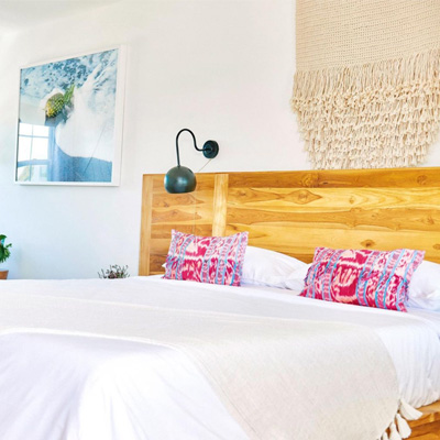 view of a bed with a wooden headboard and a large photo next to it