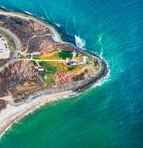 aerial view of the land around the lighthouse and the ocean