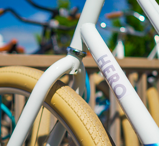 close up view of a white bicycle with the hero logo on it