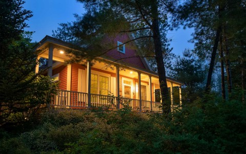 exterior of cottage with the porch lights on