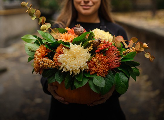 person holding a flower arrangement