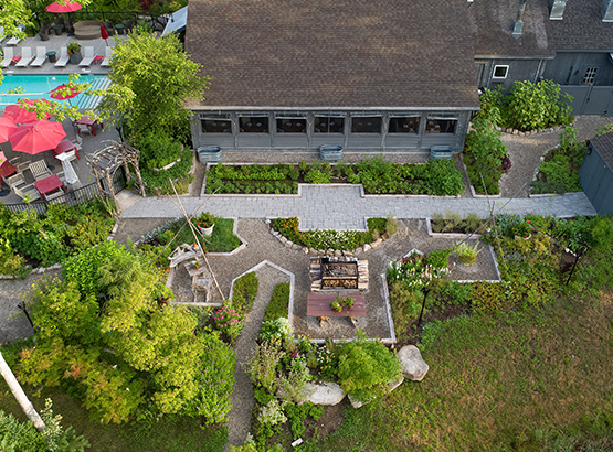 aerial view of the garden behind a building and the pool in the upper lefthand corner 