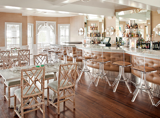 dining tables in restaurant with bar that also has seating