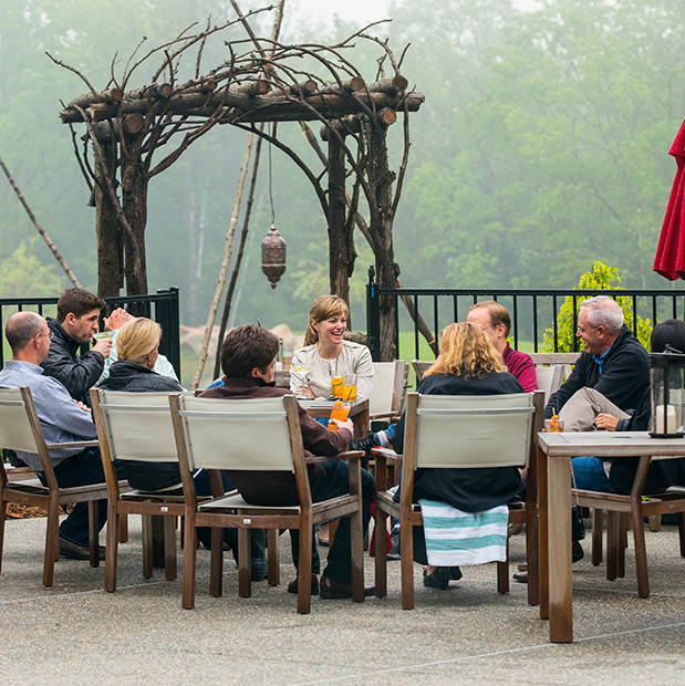 group of people sitting outside and laughing together