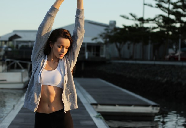 a girl stretching on the dock