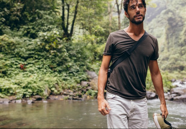 man walking through the jungle