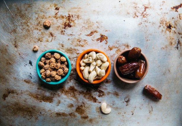 assortment of nuts in different colored bowls