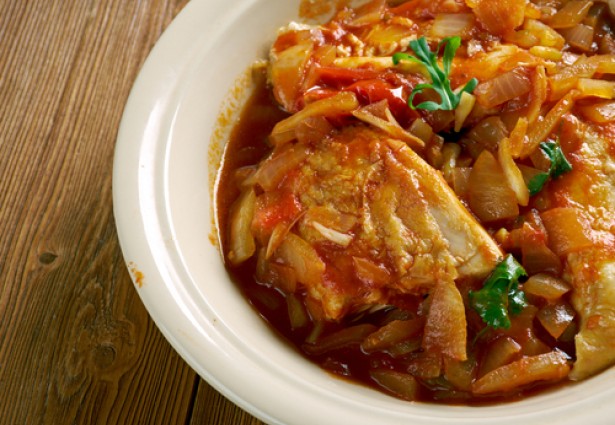 close up of a spicy dish with chicken and peppers