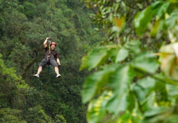 a man enjoying a zipline through the trees