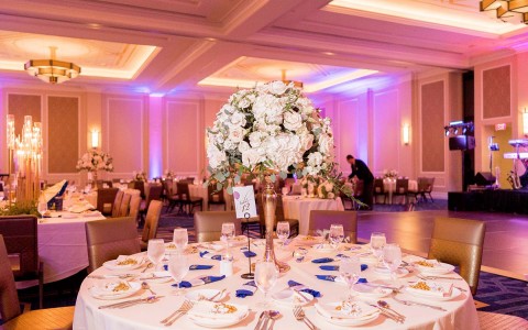 wedding table with big flower vase on it