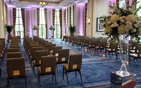 wedding room with chairs and a hall with candles 