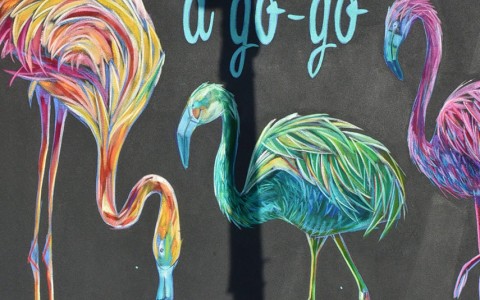 Black Poster with Neon Flamingos and text saying flamingo a go go 
