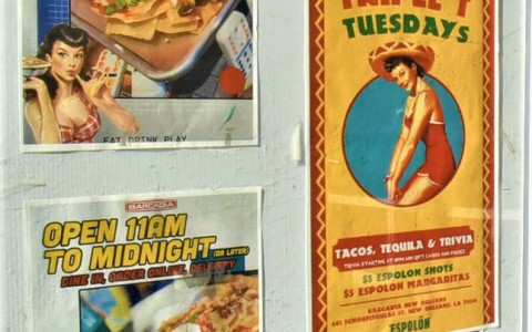 neighborhood photo showing nachos ad on a street wall