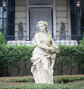 statue of female goddess outside a home