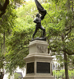 statue in tree filled park