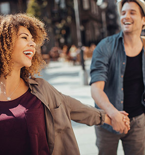 couple holding hands and laughing