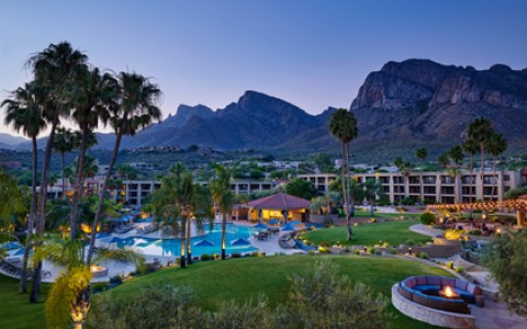 View of pool and mountains at dusk
