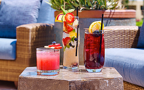 3 fruity cocktails on a marble table
