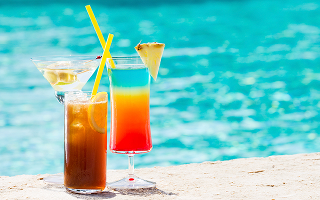 three drinks by a pool