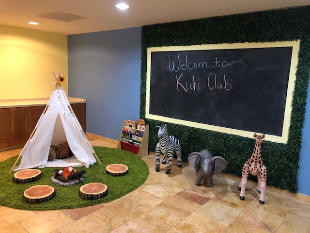 little tent and animal toys with a sign that says welcome to kids club