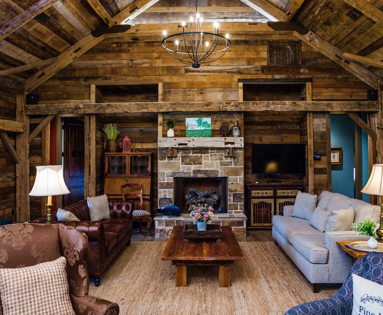 fireplace with seating area inside the wooden lodge