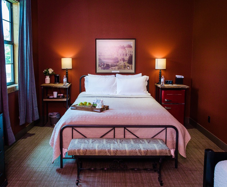 red suite with queen bed, trundle bed, storage and a connecting bathroom