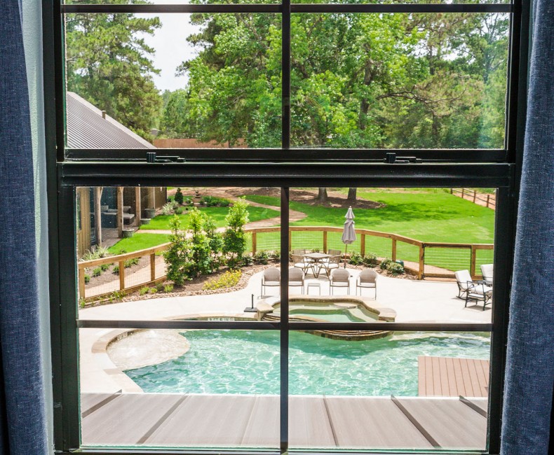 looking out from the window to the pool and greenery