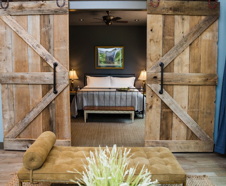 living room seating area with barn doors opening up to the bedroom