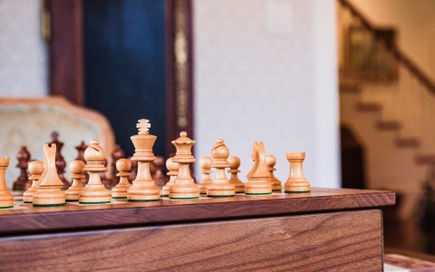 close up view of light wood chess pieces