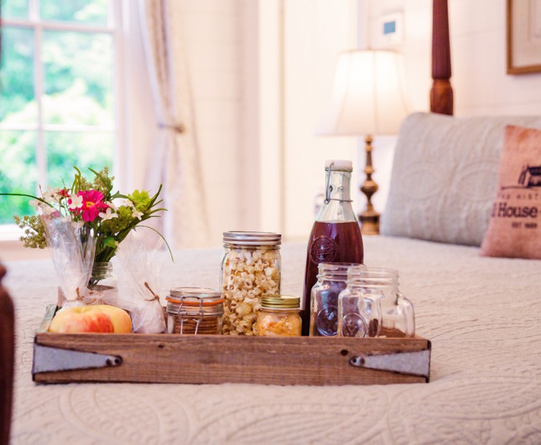 tray with breakfast foods on bed