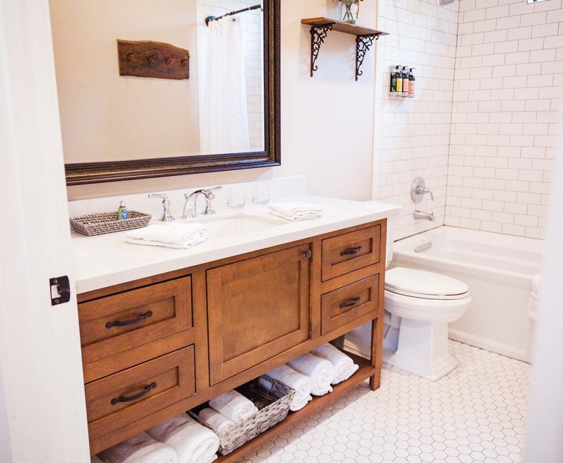 clean bathroom with single sink and large mirror