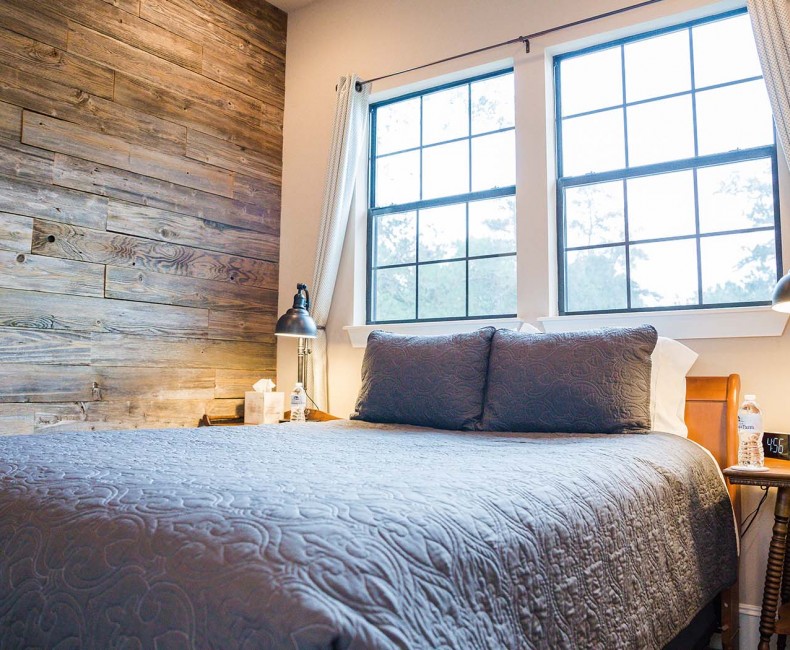 grey double bed in front of a window