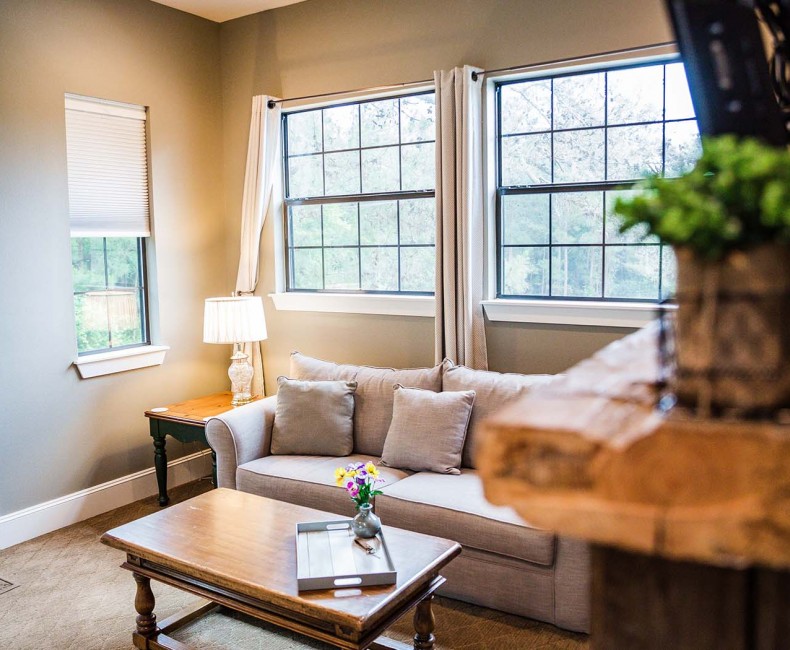 comfy beige couch in front of a window