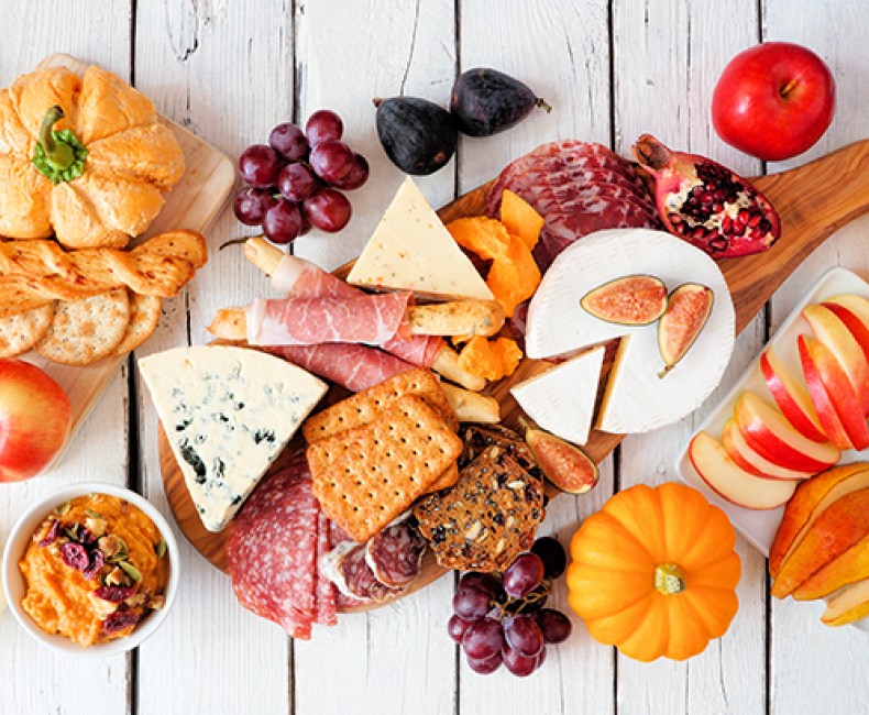 table decorated for fall with various cheeses