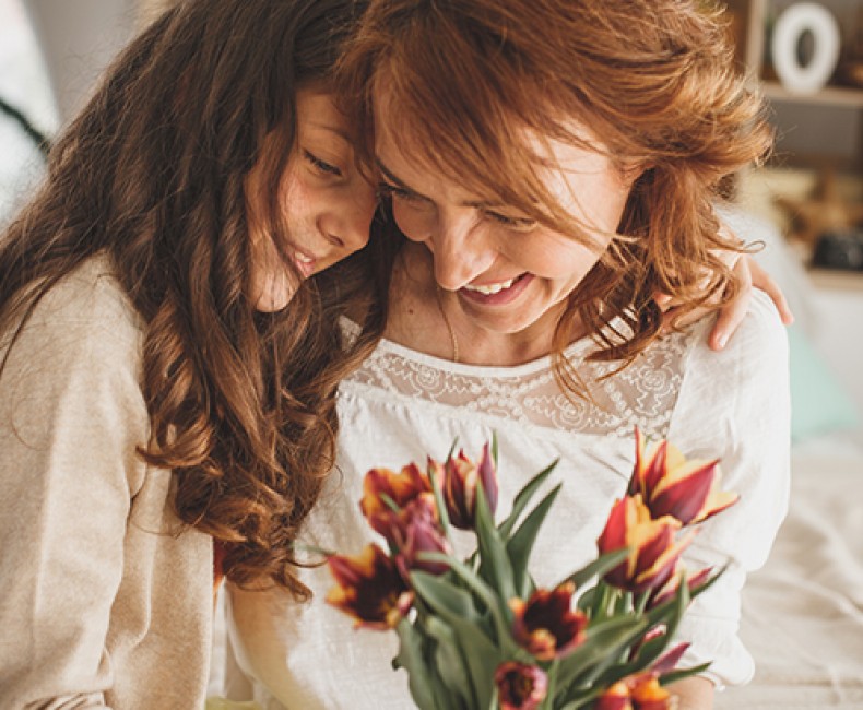 Mom and daughter laughing together
