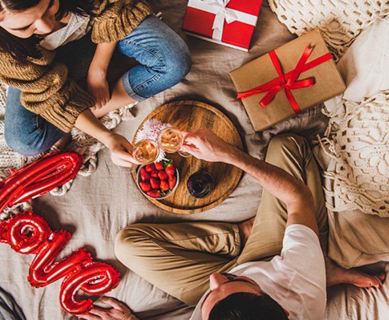 couple enjoying coffee in bed on Valentines day