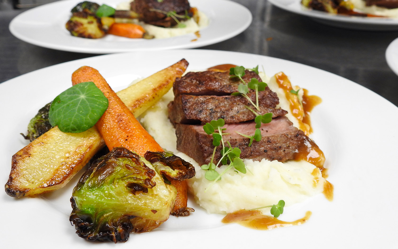 well plated steak with mashed potatoes and veggies