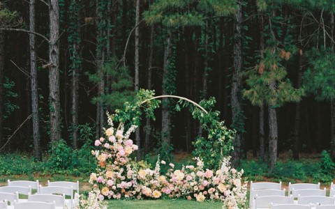 beautiful wedding arch at the end of the isle