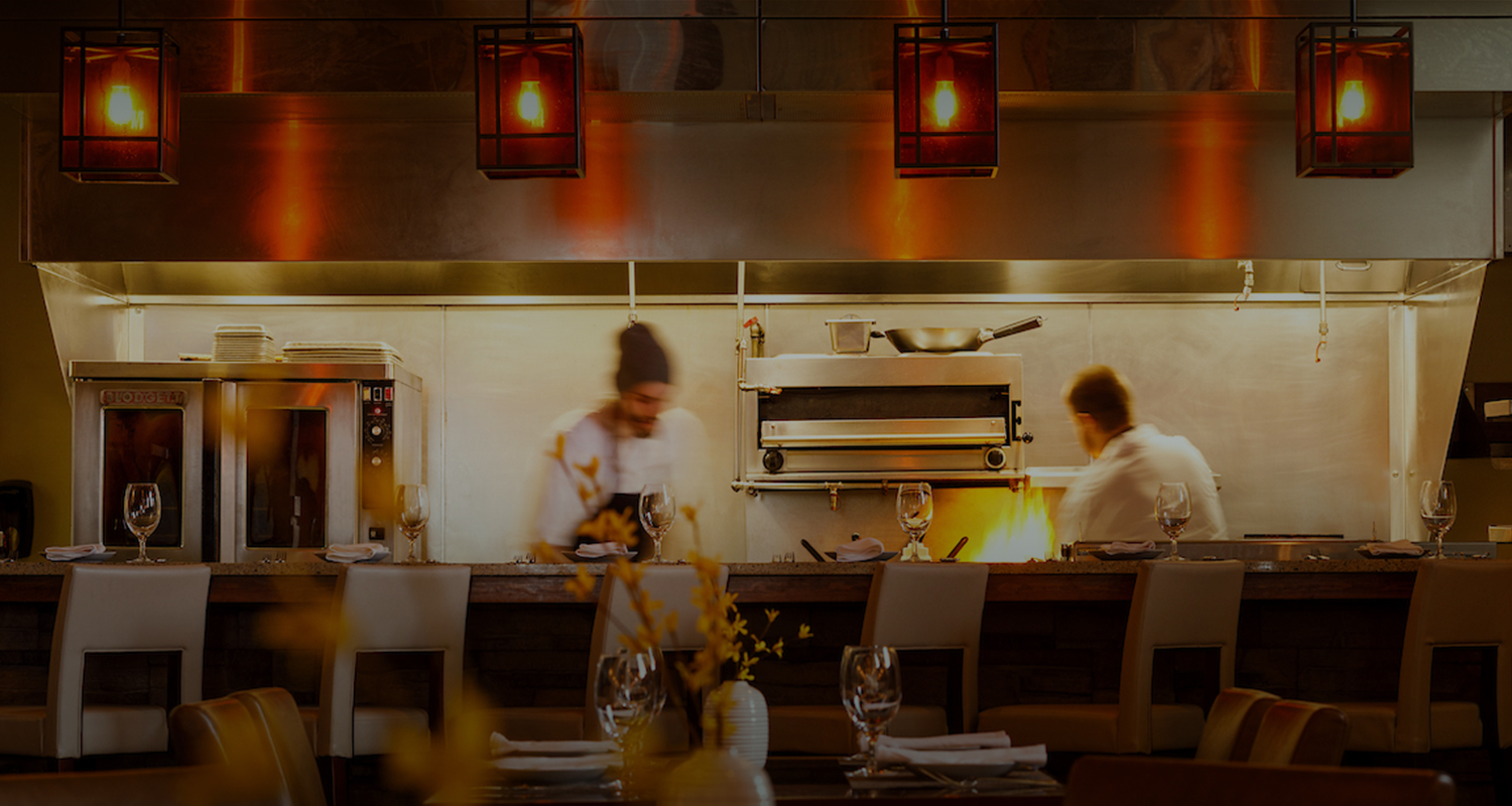 chefs cooking on the visible kitchen at a restaurant