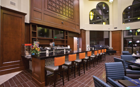 assortment of bar seating in restaurant with high ceiling