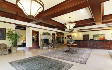 hotel interior lobby with fire place and high ceiling