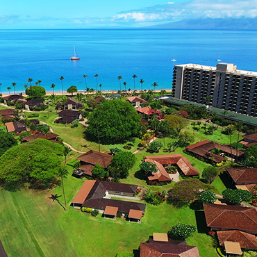 Aerial view of the hotel full of cottages and the blue sea at the background