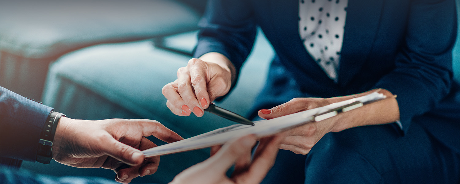 A person holding a tablet and pointing something to another person