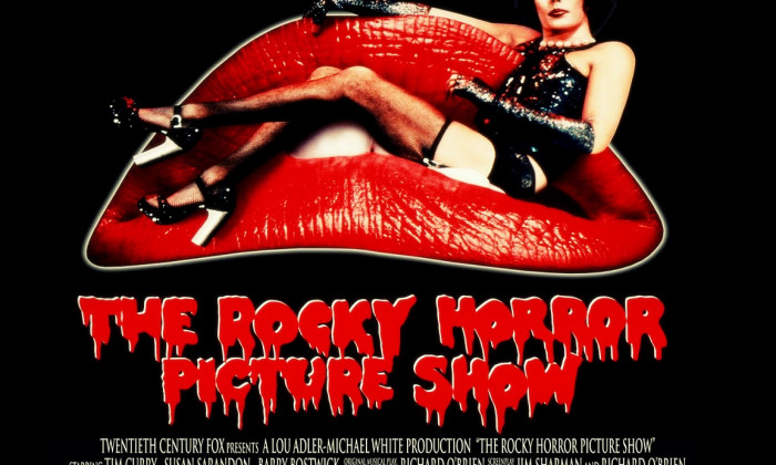 The Rocky Horror Picture Show poster with Tim Curry in costume on a couch shaped like red lips